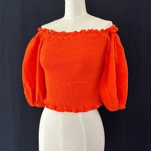 Orange, puffy sleeve off the shoulders top